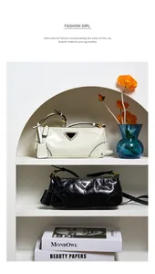 Detailed view of luxury oil wax leather shoulder bags in white and black with metal logo