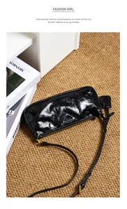 Detail of glossy oil wax leather shoulder bag with triangle metal logo and gold hardware