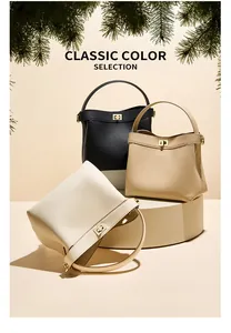 Three leather bucket bags in black, khaki and beige with gold hardware on display