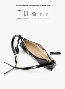 Detail view showing interior capacity of a black wax leather bag for phone and makeup