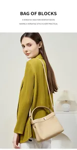 Detailed shot of beige lychee-textured leather bucket bag with metallic twist lock closure