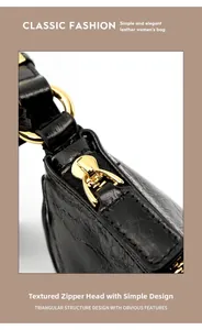 Detailed view of luxury golden zipper and glossy crocodile texture leather handbag