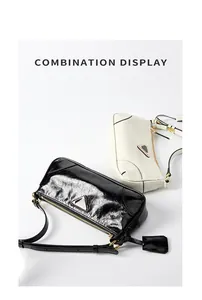 Detail view of black wrinkled oil wax leather and cream smooth leather shoulder bags
