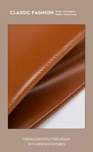 Detail showing precision machine stitching and edge oiling on brown leather tote bag