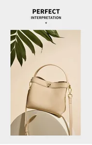 Close-up of beige pebble leather bucket bag with gold hardware and shoulder strap details