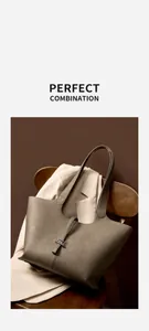 Dettaglio borsa tote in pelle grigio talpa con chiusura in metallo su sedia di legno