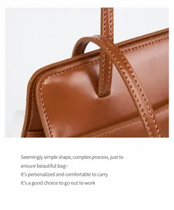 Macro shot of stitching details and leather handle connection on dark brown tote bag