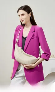 Detailed view of beige sheepskin croissant bag with vertical stitching and knotted strap
