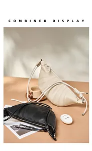 Detail view of large leather croissant bags with ribbed stitching and knot strap details