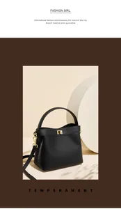 Detailed view of black pebbled leather bucket bag with gold twist lock and shoulder strap