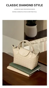 Close-up of beige woven leather texture and metal zipper on the elegant handbag