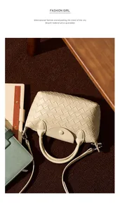 Detail of cream woven leather handbag with intricate texture and detachable strap