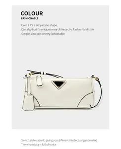 Close-up of white oil wax leather baguette bag with triangle metal logo and gold hardware
