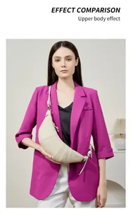 Upper body effect of a beige leather croissant bag worn with a stylish blazer