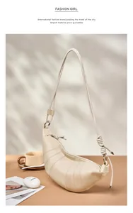 Detail of beige quilted leather croissant bag with knotted strap and silver hardware