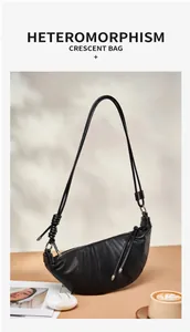 Detailed view of black genuine leather crescent croissant bag with shoulder strap and knots