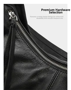 Close-up of premium silver metal zipper and lychee texture leather on a black tote bag