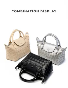 Detailed view of woven leather handbags in beige, silver, and black color options