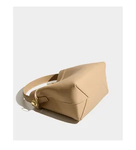 Detail of lychee pattern leather texture with fine stitching and gold metal buckle