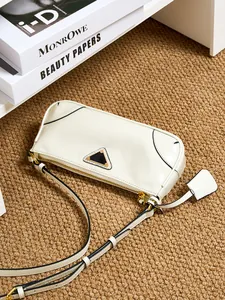 Cream oil wax leather shoulder bag with gold hardware and triangle metal detail