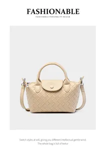 Detail of light beige woven leather texture and silver buckle on the hobo bag