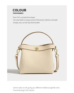 Detailed macro view of beige lychee grain leather handbag with gold twist lock and handle
