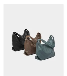 Three leather hobo bags in black, brown, and green with silver hardware and soft texture