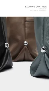 Close-up of spherical silver metal fasteners and leather texture on luxury tote bags