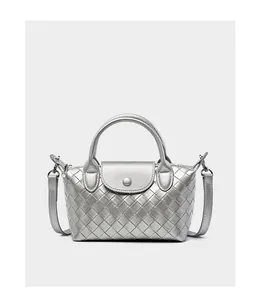 Detailed view of silver woven leather bag with metallic finish and magnetic buckle