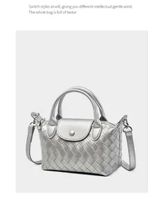 Detail showing metallic silver woven texture and round handles on the leather tote