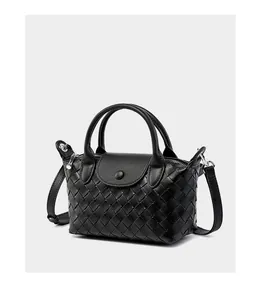 Close-up of black woven leather handbag showing Intrecciato craftsmanship and silver clasp