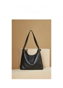 Detail view of the high-quality black leather texture on this minimalist hobo shoulder bag