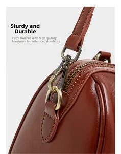 Close-up of vintage bronze hardware and fine stitching on a brown leather handbag