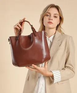Dettaglio della borsa tote in vera pelle marrone scuro con texture liscia e finiture metalliche