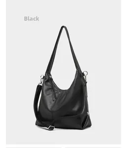 Detail view of black lychee grain leather hobo bag showing texture and metal zipper
