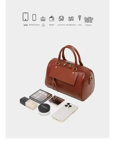 Detail view of brown leather Boston bag showing spacious interior capacity for daily essentials