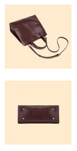 Detail view of burgundy leather tote bag with sturdy handles and bottom protective studs