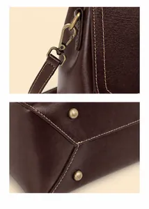 Detail view of vintage metal buckles and wear-resistant rivets on the leather handbag
