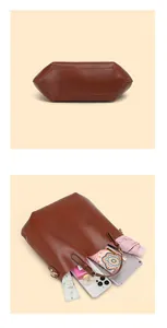 Dettaglio macro della borsa tote in pelle marrone con cuciture robuste e interno capiente
