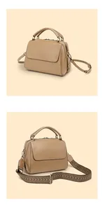 Detail der khakifarbenen Boston-Tasche aus Leder mit zwei Riemen und edler Kieselstruktur