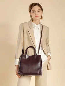 Vertical genuine leather tote bag in dark wine red with top handles and shoulder strap