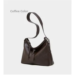 Detail of coffee brown genuine leather hobo bag showing texture and adjustable strap