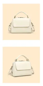 Detailansicht der cremefarbenen Leder-Boston-Tasche mit antik bronzenen Metallteilen