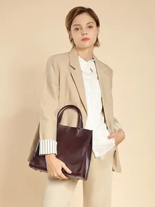 Minimalist burgundy leather tote bag in a spacious vertical design for business women