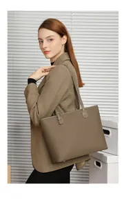 Macro detail of khaki litchi grain leather tote bag with metal buckle side strap