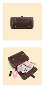 Detail of dark brown leather handbag showing bottom metal studs and spacious interior
