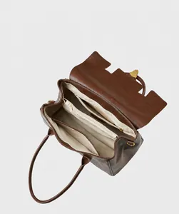 Detailed interior of the leather tote bag showing multiple compartments and zipper pockets