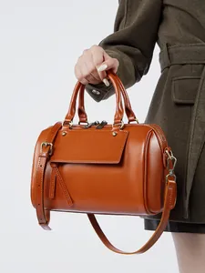 Classic brown leather Boston handbag for women with dual handles and adjustable shoulder strap