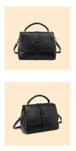 Detail view of black leather handbag with contrast stitching and bronze hardware