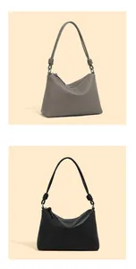 Detail von minimalistischen Ledertaschen mit seitlichen Knoten in Grau und Schwarz